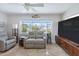 Comfortable living room with natural light, a TV, and cozy seating at 1030 Haste Ln, Englewood, FL 34223