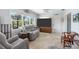 Inviting living room with a large TV, comfortable seating, and an open layout at 1030 Haste Ln, Englewood, FL 34223