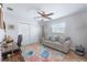 Office space with a comfortable sofa, desk, and colorful rug in a well-lit room at 1030 Haste Ln, Englewood, FL 34223