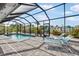 Screened-in pool area with patio furniture overlooking the canal at 1030 Haste Ln, Englewood, FL 34223