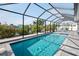The screened pool area is surrounded by lush greenery, offering a serene outdoor escape at 1030 Haste Ln, Englewood, FL 34223