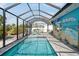 Large screened pool with inviting sun loungers, scenic views, and access to a lush backyard at 1030 Haste Ln, Englewood, FL 34223