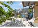 Backyard with an enclosed pool, patio, and tropical foliage providing privacy at 1030 Haste Ln, Englewood, FL 34223