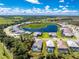 Aerial view of the home featuring a screened-in pool and lake views at 11044 Hogan Cir, Englewood, FL 34223