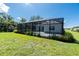 Spacious backyard with a screened-in pool and lush landscaping providing privacy and beauty at 11044 Hogan Cir, Englewood, FL 34223