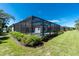 Landscaped backyard with a screened-in pool featuring an abundance of greenery and privacy at 11044 Hogan Cir, Englewood, FL 34223