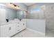 Modern bathroom featuring double sinks and a walk-in shower at 11044 Hogan Cir, Englewood, FL 34223