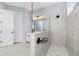 Bathroom showcasing the walk-in shower and vanity with double sinks at 11044 Hogan Cir, Englewood, FL 34223