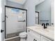 Bathroom featuring a walk-in shower with subway tile surround and modern glass door at 11044 Hogan Cir, Englewood, FL 34223