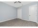 Bedroom featuring neutral walls, wood-look tile flooring, and a spacious closet at 11044 Hogan Cir, Englewood, FL 34223