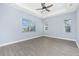 Bedroom showcasing the tray ceiling and views from the windows at 11044 Hogan Cir, Englewood, FL 34223