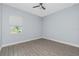 Bedroom with neutral walls, a ceiling fan, and wood-look tile flooring at 11044 Hogan Cir, Englewood, FL 34223