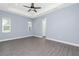 Spacious bedroom with tray ceilings, a fan and wood floors at 11044 Hogan Cir, Englewood, FL 34223
