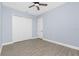 Bedroom featuring neutral walls, wood-look tile flooring, and a spacious closet at 11044 Hogan Cir, Englewood, FL 34223
