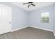 This bedroom features wood flooring, a ceiling fan and a window at 11044 Hogan Cir, Englewood, FL 34223