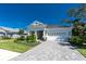 Charming single-story home with a paved driveway and a well-manicured lawn at 11044 Hogan Cir, Englewood, FL 34223