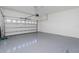 Spacious two-car garage with epoxy flooring and a white garage door at 11044 Hogan Cir, Englewood, FL 34223