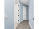 Hallway featuring wood floors and white doors at 11044 Hogan Cir, Englewood, FL 34223