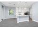 Modern kitchen boasting white cabinets, a center island, stainless steel appliances, and wood-look floors at 11044 Hogan Cir, Englewood, FL 34223