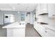 Bright kitchen with white cabinets, stainless steel appliances, and a center island overlooking backyard at 11044 Hogan Cir, Englewood, FL 34223