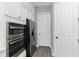 Modern kitchen with built-in stainless steel appliances and ample white cabinetry at 11044 Hogan Cir, Englewood, FL 34223
