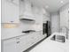 Well-equipped kitchen with white cabinetry, stainless steel appliances, and ample counter space at 11044 Hogan Cir, Englewood, FL 34223