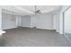 Spacious living room with wood-look floors, tray ceiling, and open layout at 11044 Hogan Cir, Englewood, FL 34223
