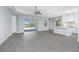 Open living area showcasing a kitchen with a center island and sliding glass doors to the backyard pool at 11044 Hogan Cir, Englewood, FL 34223