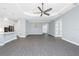 Open concept living area with wood-look floors, neutral paint, and an easy flow to the kitchen at 11044 Hogan Cir, Englewood, FL 34223