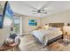 Comfortable bedroom featuring a sliding glass door to a balcony and beach-themed decor at 1401 S Mccall Rd # 205, Englewood, FL 34223