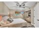 Serene bedroom with coastal decor, flatscreen TV, and a sunny window with bamboo blinds at 1401 S Mccall Rd # 205, Englewood, FL 34223