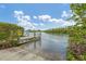 Picturesque waterfront views from the community's private boat dock with lush landscaping at 1401 S Mccall Rd # 205, Englewood, FL 34223