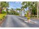 Community entrance with lush landscaping and signage at 1401 S Mccall Rd # 205, Englewood, FL 34223