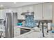 Updated kitchen with stainless steel appliances and custom backsplash at 1401 S Mccall Rd # 205, Englewood, FL 34223