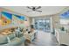 Bright living room features a slider to a screened lanai overlooking the water at 1401 S Mccall Rd # 205, Englewood, FL 34223