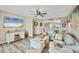 Inviting living room with a coastal design, modern furniture, and entertainment center with a flat screen TV at 1401 S Mccall Rd # 205, Englewood, FL 34223