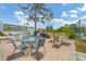 Outdoor patio area with multiple tables and chairs at 1401 S Mccall Rd # 205, Englewood, FL 34223