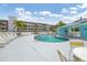 Community pool with blue water, sun loungers and trees at 1401 S Mccall Rd # 205, Englewood, FL 34223