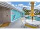 Community pool area with shower and yellow striped lounge chairs at 1401 S Mccall Rd # 205, Englewood, FL 34223