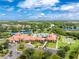 Expansive aerial view showcasing the community's clubhouse, pool, tennis courts, and lush landscaping at 1530 Hyssop Loop, North Port, FL 34289