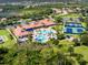 Aerial view of community amenities featuring a large pool, tennis courts, and lush landscaping at 1530 Hyssop Loop, North Port, FL 34289