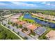 Aerial view of a charming neighborhood with beautiful lake views and manicured lawns at 1530 Hyssop Loop, North Port, FL 34289