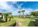 Beautiful backyard view showcasing mature trees, a serene pond, and meticulously maintained landscaping at 1530 Hyssop Loop, North Port, FL 34289