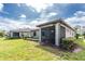 Landscaped backyard with a screened-in patio and green grass at 1530 Hyssop Loop, North Port, FL 34289