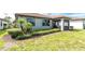 Landscaped backyard featuring lush green grass and manicured shrubs, creating a serene outdoor space at 1530 Hyssop Loop, North Port, FL 34289