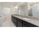 Bright bathroom with a double vanity, granite countertops, and tile flooring at 1530 Hyssop Loop, North Port, FL 34289