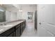 Bathroom with a granite countertop vanity and doorway views into the bedroom and shower at 1530 Hyssop Loop, North Port, FL 34289