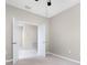 Bedroom featuring a ceiling fan, neutral carpeting, and a doorway at 1530 Hyssop Loop, North Port, FL 34289