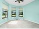 Bright bedroom with ample natural light, a ceiling fan, and neutral carpeting at 1530 Hyssop Loop, North Port, FL 34289
