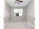 Neutral bedroom featuring a ceiling fan, a window, and neutral carpeting at 1530 Hyssop Loop, North Port, FL 34289